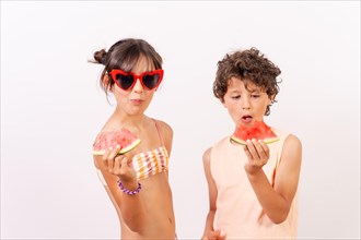 Children enjoying the summer with eating a watermelon