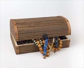 Half-opened wooden box with colourful pearl jewellery
