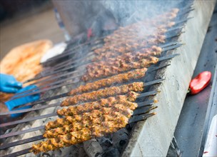Turkish Adana/Urfa kebab being grilled in the view