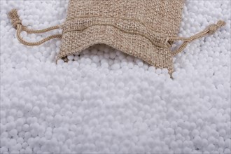 Little sack in White polystyrene foam balls as background