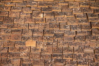 Tiled roof made of handmade tiles as texture or background
