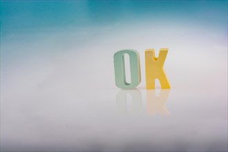 The word OK written with colorful letter blocks
