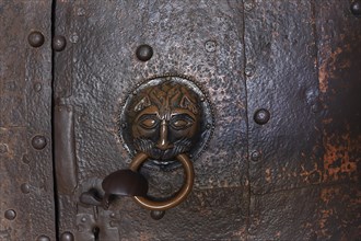 Historic door knocker on the door to the monastery church
