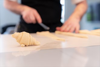 Detail of a man's hands baking croissants