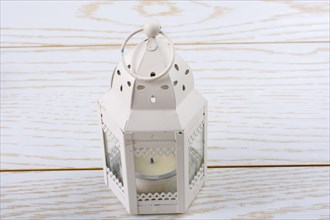 Old retro style lantern made of metal in hand