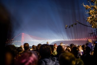 Crowd watch fireworks show over the Istanbul City View of Bosporus Bridge