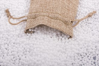Little sack in White polystyrene foam balls as background