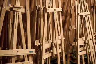 Dozens of of wooden easels in a room