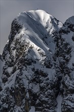 Peak of the Koellenspitze in snowy mountain landscape