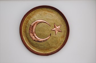Crescent and star made of metal resembling a Turkish flag