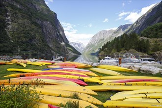 Many kayaks lying on the shore of the Naerofjord at the village of Gudvangen in Norway