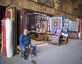 Egyptian man sitting at a paisley shop