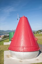 Large red marine buoy