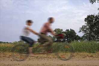 Two people riding on a tandem