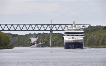 Cruise ship HANSEATIC inspiration and container ship sailing in the Kiel Canal at Gruenentaler Bruecke