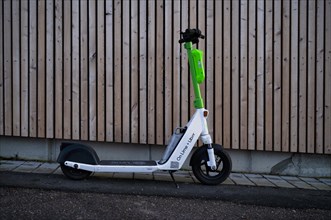 Electric scooter parked on the side of the road at the bike rental company Lime