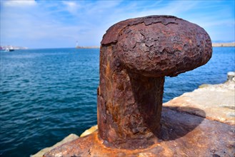 Rusted bollard at a harbour quay in Marseille