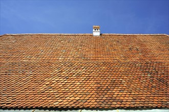 Roof with plain tiles of an old farmhouse from 1695