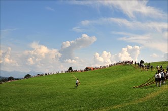 Alphorn players on an alpine meadow in Allgaeu