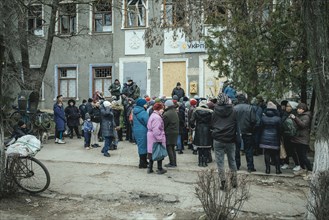Residents of the small town of Snihurivka wait in front of the post office for the first payment of money to tide them over 1200 Hrivny