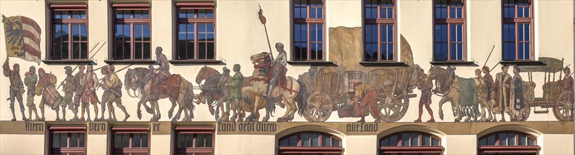 Historical mural of a medieval merchant procession