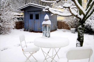 Garden table with chairs under a blanket of snow in winter