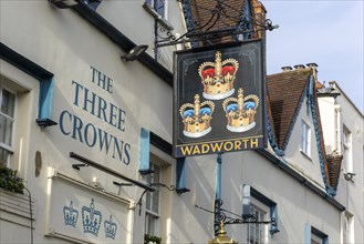 Pub sign for Wadworth brewery Three Crowns inn