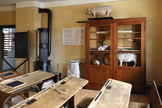 Classroom with cannon stove and biology cupboard