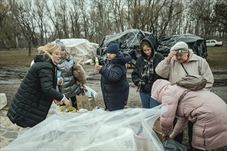 Residents of the house destroyed by a Russian missile attack that killed 45 people receive relief goods from neighbourhood donations