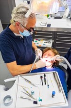 Dentist does dental prophylaxis performs dental treatment caries treatment