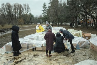 Residents of the house destroyed by a Russian missile attack that killed 45 people receive relief goods from neighbourhood donations