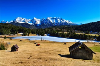 Alpine meadows with hay barn above Lake Gerold in Upper Bavaria