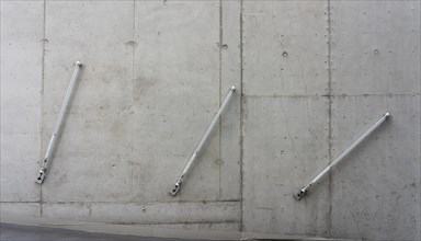 Fluorescent tube on bare concrete wall