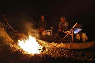 In the evening in the camp by the fire