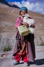 Elderly woman with at goat