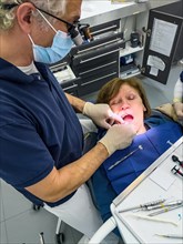 Dentist examines patients dentition