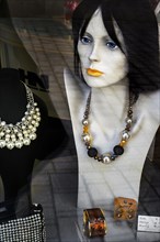 Shop window with bust of woman and necklaces
