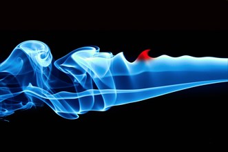 Blue smoke of an incense stick against a black background