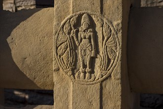 Round motif depicting a woman