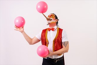 Smiling juggler juggling balls isolated on white background