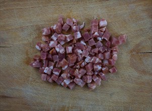 Diced ham on wooden board