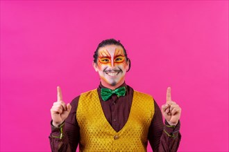 Clown with white face makeup showing empty space on pink background