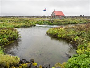 Icelandic flag in front of hut in the highlands of Iceland