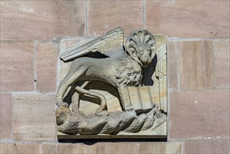 Historical house sign with the lion of St Mark on a residential and commercial building