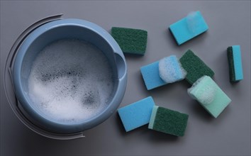 Many cleaning sponges with cleaning bucket and foam