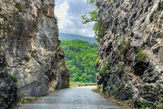 Narrow road Country road without markings through narrow rocky passage in mountainous landscape in southern France