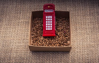 Red color phone booth in a box on a canvas background
