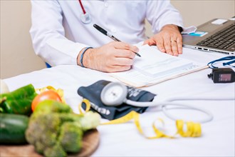 Nutritionist hands taking medical records in the office