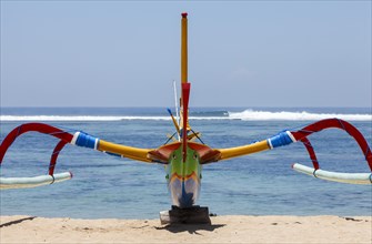 Brightly painted fishing outriggers on the beach at Sanur