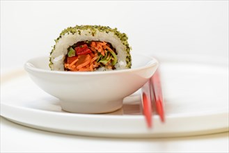 Vegetarian sushi in bowls and chopsticks